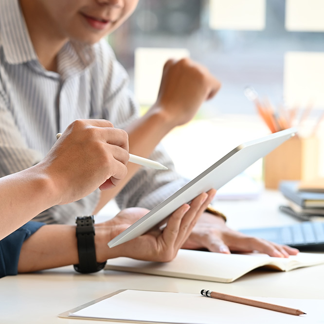 two people looking at a ipad