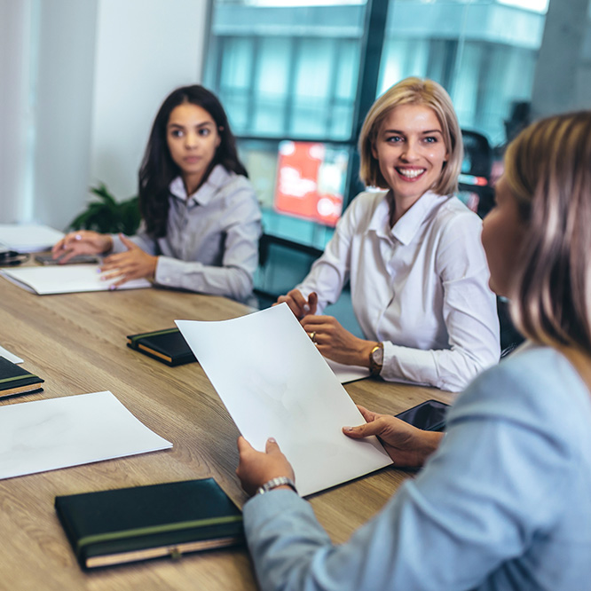 team of businesswomen having discussions and smiling