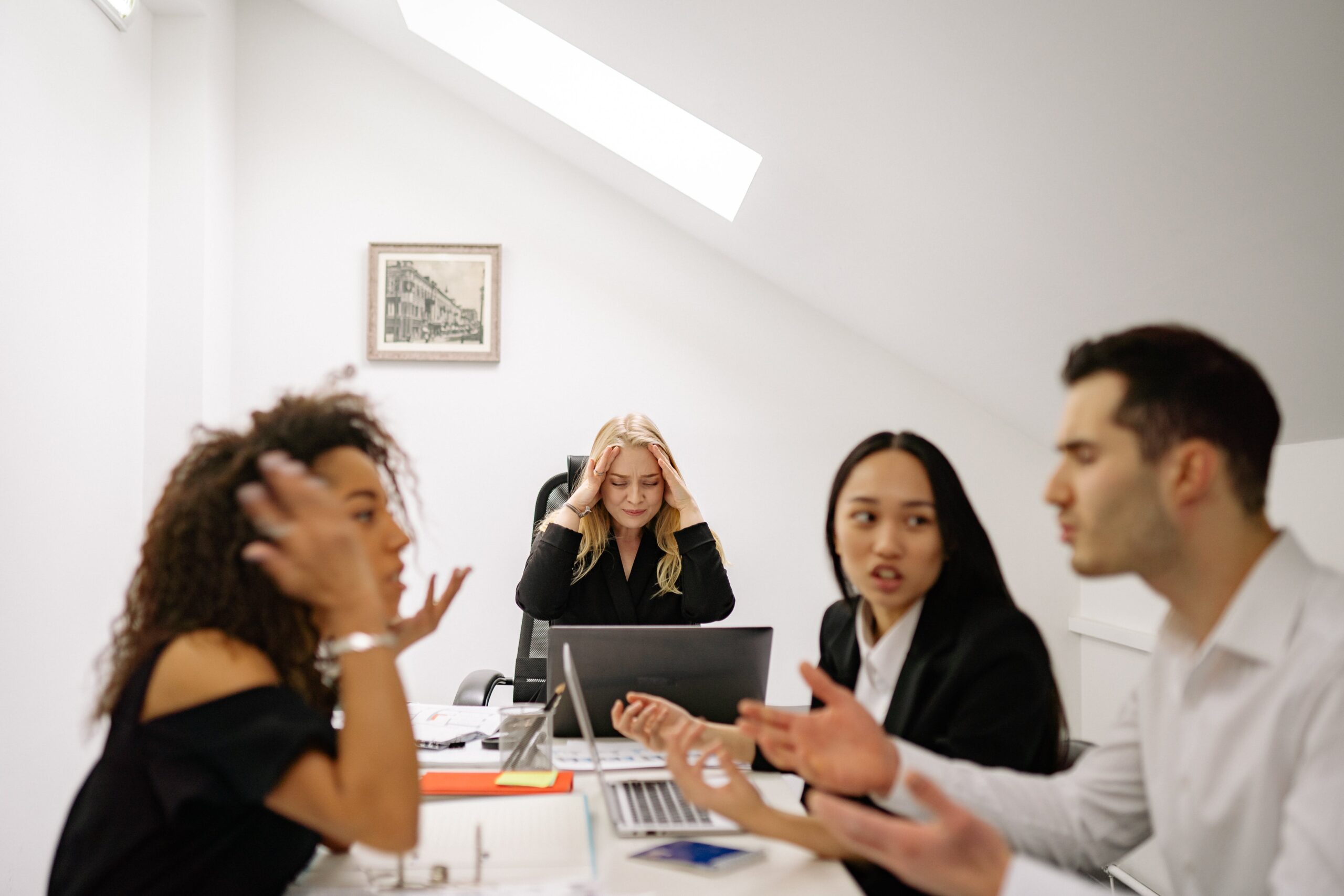 Frustrated woman in a meeting where team is disagreeing