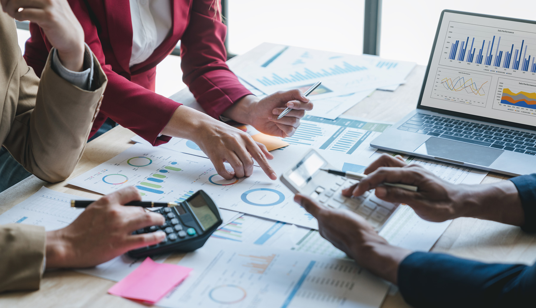 Teamwork of business people discussing and calculating with calculator on evaluation data in conference room.